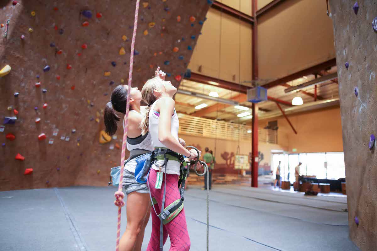 young girls looking up at climbing wall