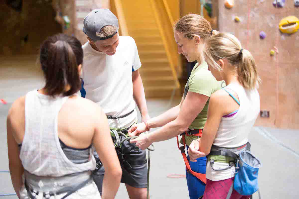 camp coach adjusting harness