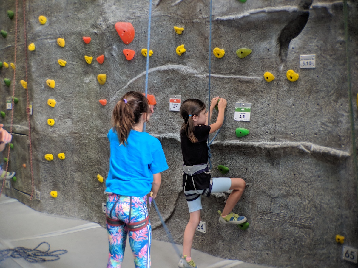 two young girls top rope climbing