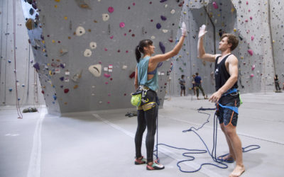 two climbers give each other a high five