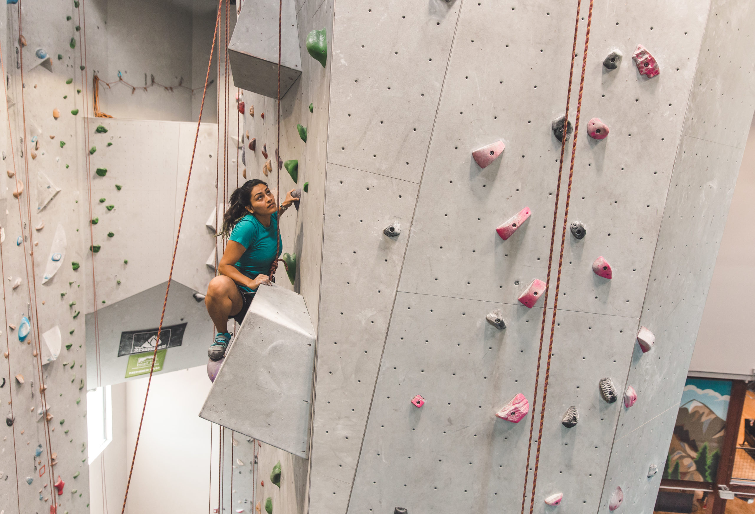 man hanging on a climbing rope